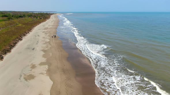 Family Riding Horses on the Seashore