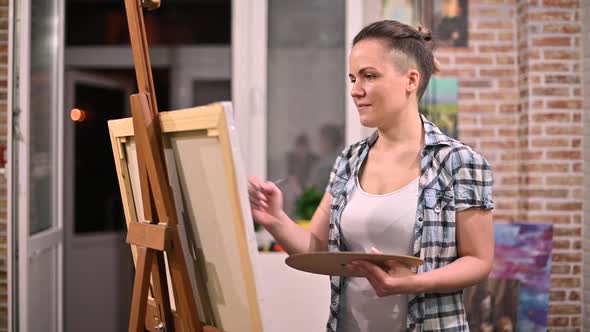 woman makes a picture in her creative studio late at night