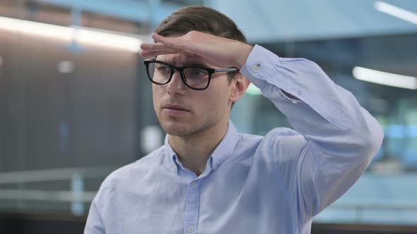 Portrait of Young Man Looking Around Searching