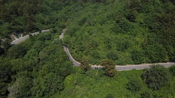 Aerial View From Above of Curve Road with a Car on the Mountain with Green Forest in Russia