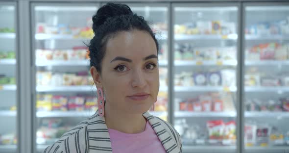 Portrait Young Woman in a the Grocery Department of a Supermarket Is Buying Up Food Concept Where