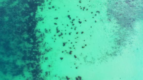 Aerial above panorama of idyllic resort beach journey by blue green ocean and white sand background 