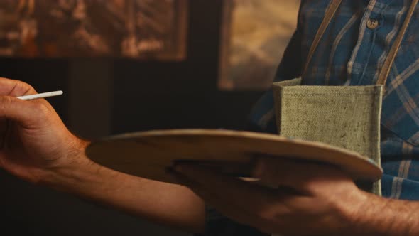 The Artist Draws a with Oil Paints