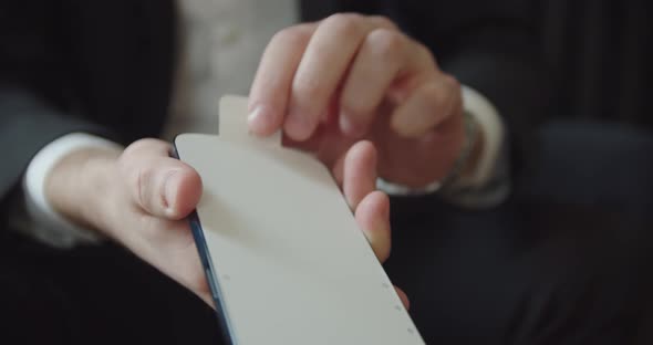Man's Hands Removes Film From New Smartphone