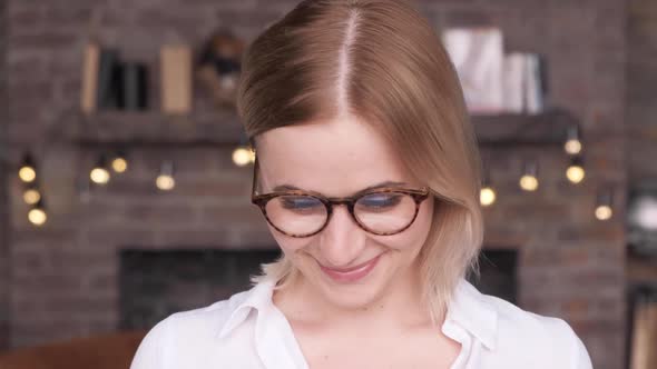 Business woman wearing eyeglasses working in dark office at night. Busy girl at work with laptop 