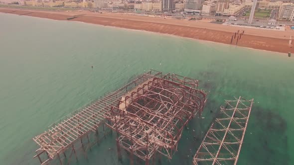 Burnt old West Pier, Brighton, Sussex, England. Aerial drone reveal