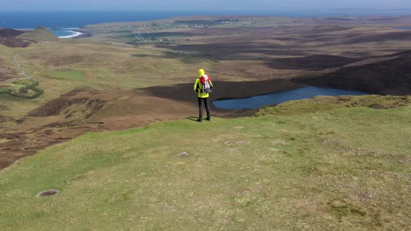 Man adventurer with backpack exploring Isle of Skye