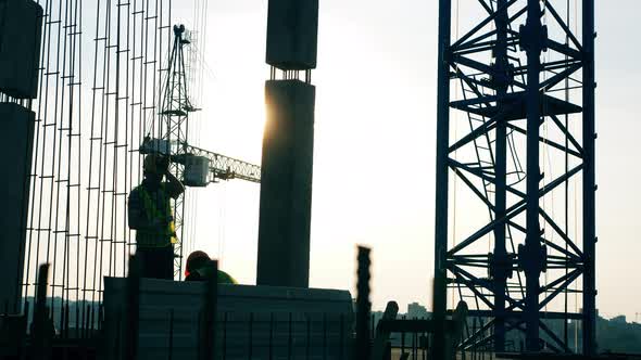 Builders in Uniform Working on Construction Site