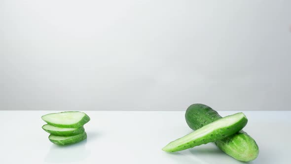 a Woman's Hand Puts Takes From the Table on Which Lies a Cucumber a Tube with a Refreshing Cucumber