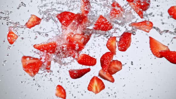 Super Slow Motion Shot of Fresh Strawberries and Water Side Collision on White at 1000Fps