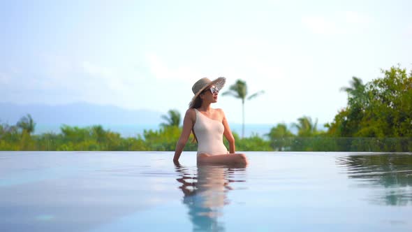 Young asian woman enjoy around outdoor swimming pool for leisure