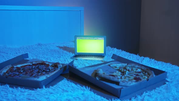 Empty Bedroom with Two Pizza and Notebook with Green Screen on Bed