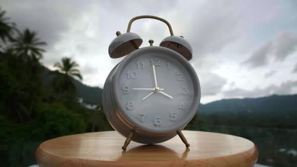 Time Lapse of Vintage Alarm Clock on Tropical Nature Background