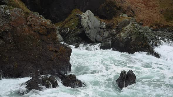 Large Storm Waves Crashing Onto Rocks In Isle Of Man. Slow Motion, Locked Off