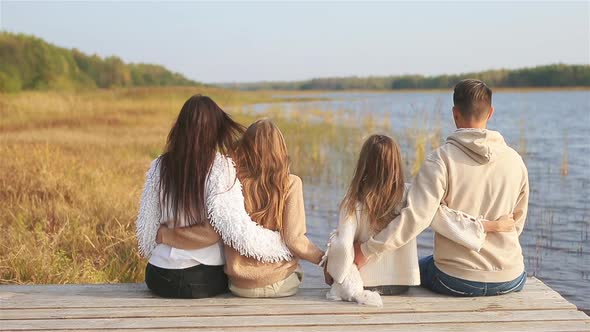 Beautiful Family at Autumn Warm Day Near Lake