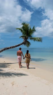 Anse Takamaka Beach Mahe Seychelles Tropical Beach with Palm Trees and a Blue Ocean Couple Man and