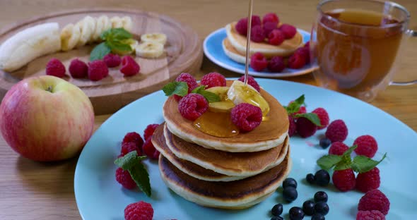 Sweet Honey Pouring Over Pancakes