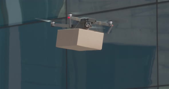 Drone Lifting Up Carton Package in Empty City