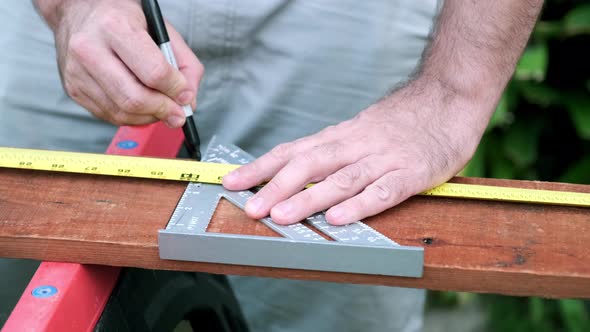 Carpenter Prepares Wood for Woodworking Project, Slow Motion Taking of Measurements on Wood Plank