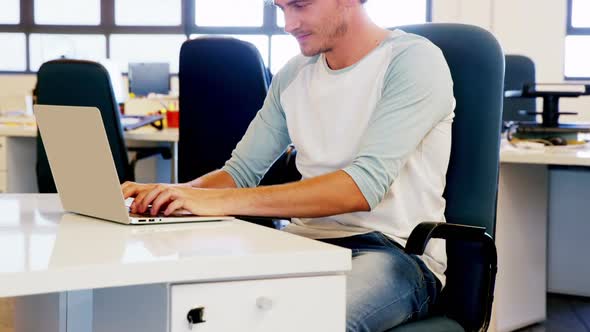 Smiling man working on laptop