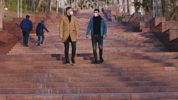 Two Guys with a Protective Mask Walking Down the