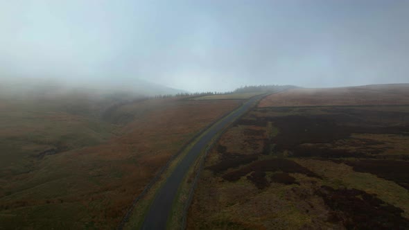 Forward low-level drone aerial over the North York Moors National Park in England on a foggy autumn