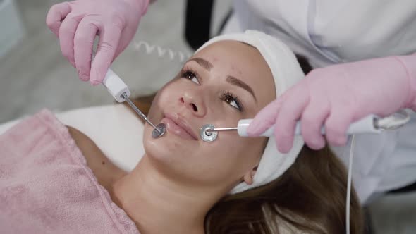 Happy Girl Having Relax During Face Skin Rejuvenation with Microcurrent Device