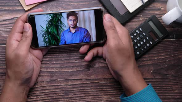 Businessman In a Video Conference Display on Smart Phone Screen 