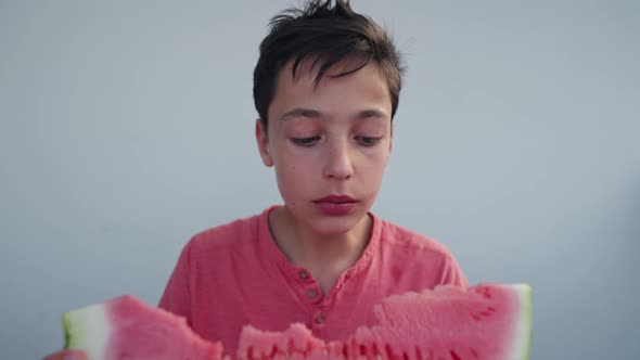 Caucasian Boy Eats Watermelon at Home