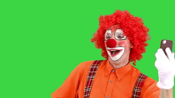 Happy Clown Taking Selfie with Smartphone on a Green Screen Chroma Key