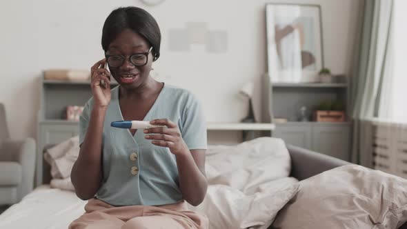 Woman Telling Pregnancy Test Result by Phone