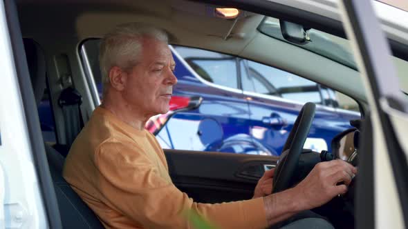 Man Examines Interior of the Car