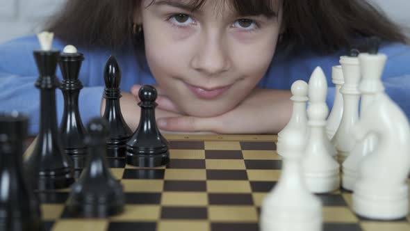 Portrait of a child with chess.