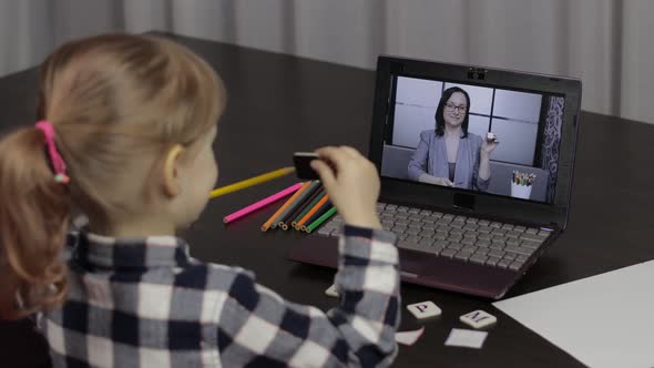 Girl Distance Education Lesson with Woman Teacher, Using Digital Laptop at Home