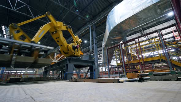 Automated Arm Moves Bricks at a Plant.