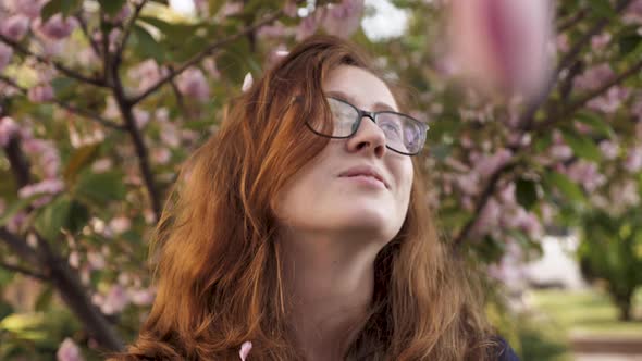 The Girl Blows Sakura Petals