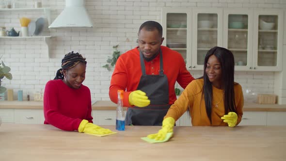 African Single Parent Family Making Spring Cleaning at Home