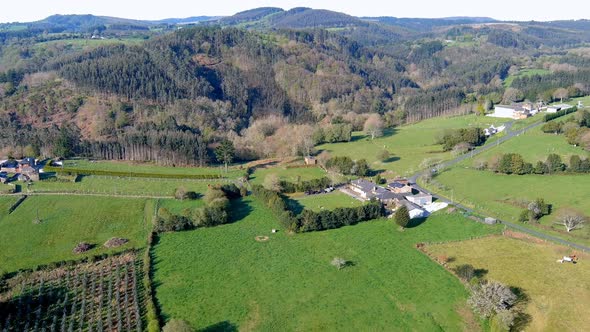 Aerial drone forward moving shot over an old house  been converted into rural tourist house in Manón