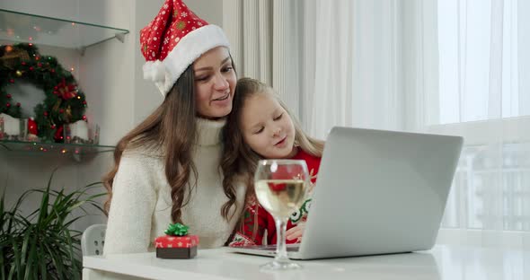 New Year's Concept Mom Her Daughter Christmas Costumes Make Online Call Laptop