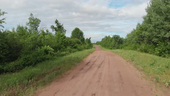 endless dirt forest road rural isolated alone driving lost sunset beautiful