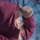 A Happy Girl in Mittens Looks in the Distance on a Frosty Winter Day - VideoHive Item for Sale