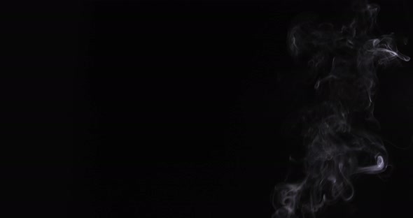 A 4k footage. Shot of smoke leak curving sideways on black background. VFX Video Element.