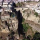 Aerial drone view of The Puente Nuevo in Ronda village on the cliff of the mountain - VideoHive Item for Sale
