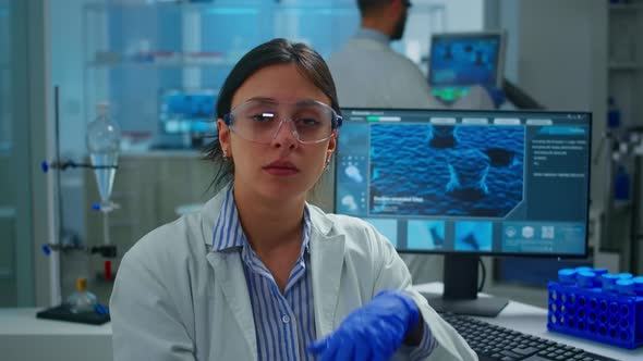 Outbreak Chemist Looking Tired at Camera Yawning Working in Lab