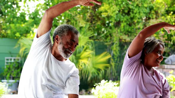 Senior couple exercising at home