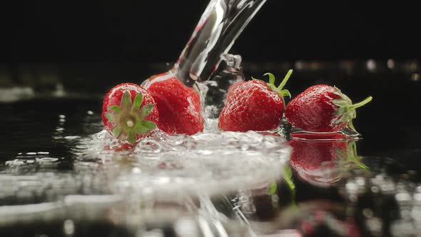 Fresh Strawberries Splashing on Slow Motion with Reflections for Natural Juicy