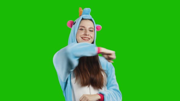 Portrait of a young brunette girl in unicorn costume
