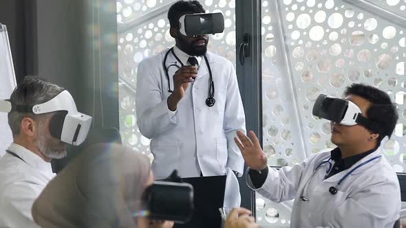 Doctor Working with Virtual Reality Glasses Together with His Multiracial Doctors-Colleagues