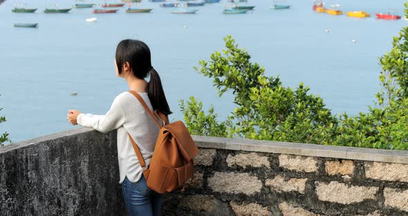 Woman taking photo with the sea 