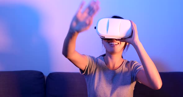 Woman watching with VR device at home